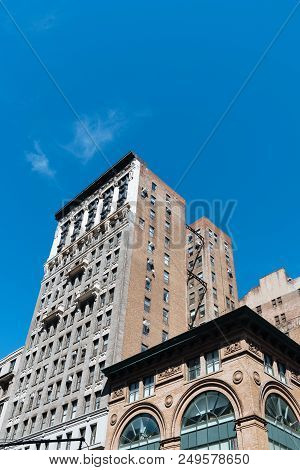 Low Angle View Of Old Buildings Against Sky In Midtown Of Manhattan, New York City