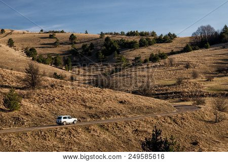 Russian Suv Lada Niva (vaz 2121) . The Car Goes Along The Mountain Road. Republic Of Crimea. March 7