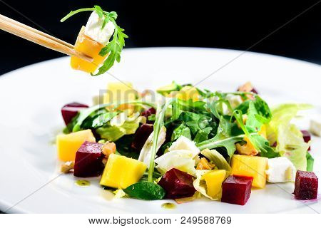 Process Of Eating With Chinese Chopsticks Delicious And Appetizing Salad With Beetroot And Fruit Man