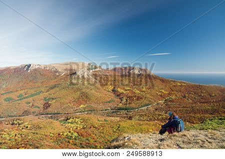 The Tourist Looks At The Demerdzhi Mountains, The Autumn Forest And The Road From Simferopol To Alus