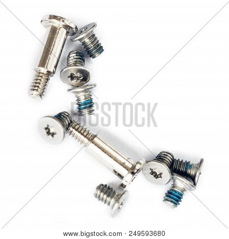 Small Laptop Screws Isoltaed On White Background. Electronics Repair Workshop Concept.