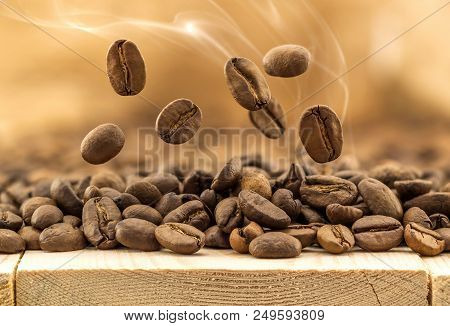 Flying Fresh Coffee Beans As A Background With Copy Space. Coffee Beans Falling Down With White Stea