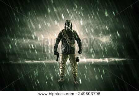 Terrorist in a stormy space with gas mask on his hand and weapons on his arm