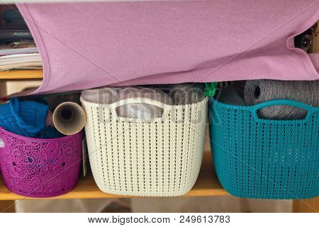 Colorful Plastic Baskets With Natural Multicolored Woolen Yarn. Wide Knitten Unfinished Pink Scarf H
