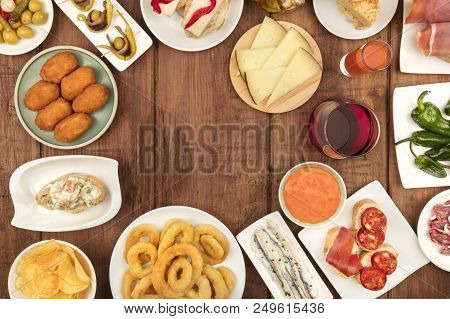 The Food Of Spain. Overhead Photo Of Many Different Spanish Tapas, Shot From Above On A Dark Rustic 