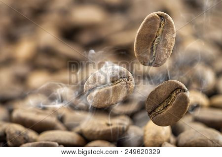 Flying Fresh Coffee Beans As A Background With Copy Space. Coffee Beans Falling Down With White Stea