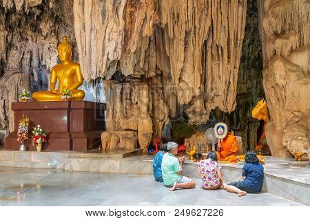 Kanchanaburi, Thailand - May 13, 2018: Group Of People Making Merit By Offering Things To Buddhist M
