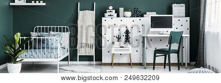 Blanket On Ladder Standing Next To Metal Bed For Teenager In Green Room Interior With Decor And Empt