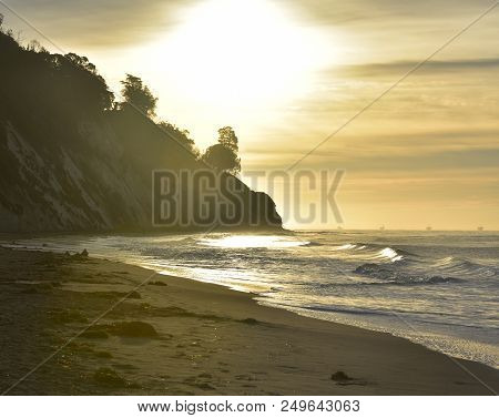 Breathtaking Sunrise With A Colorful Sky Silhouetted Cliffs