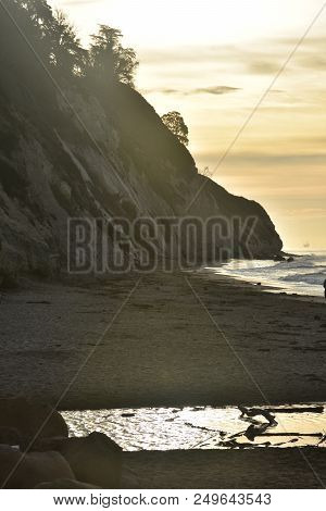 Large Cliffs With A Sun Rising Behind The Cliff