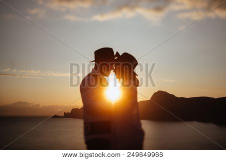 Romantic Summer Love Story On A Sunset In Mountains. Young Girl And Boy In Love.