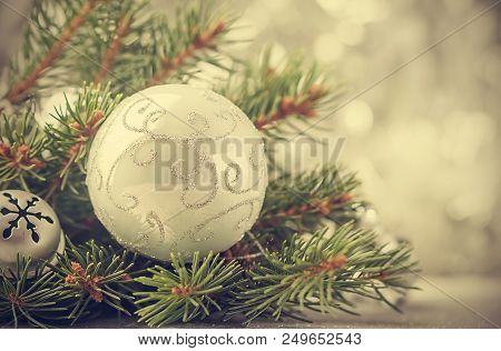 Silver Christmas Background Of Defocused Bokeh Lights With Decorated Fir Tree Branches