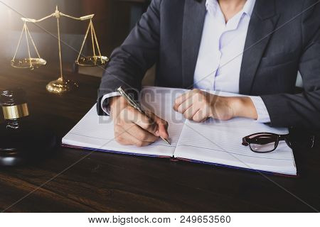 Advice And Justice Concept. Justice Scales And Justice Hammer And Female Lawyer Use Pen, Working Leg