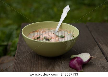 Fish Soup On An Old Wooden Table In Nature Among The Green Grass