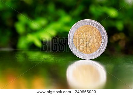 Two Euro Coin Closeup On Silver And Green Background.