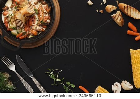 Chicken Stew With Vegetables Served In Cast Iron Pan On Black Background, Top View, Copy Space For T