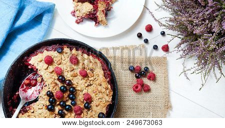 Summer Breakfast. Crumble With Blueberries In The Black Cast-iron Frying Pan On The White Table. Top