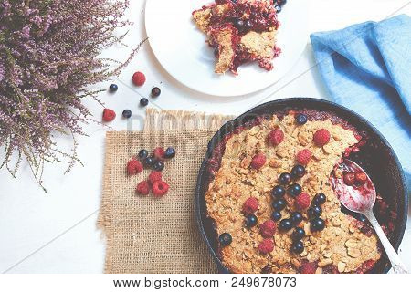 Summer Breakfast. Crumble With Blueberries In The Black Cast-iron Frying Pan On The White Table. Top