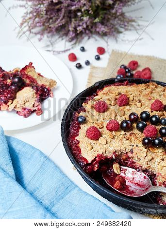 Summer Breakfast. Crumble With Blueberries In The Black Cast-iron Frying Pan On The White Table. Top