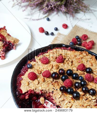 Summer Breakfast. Crumble With Blueberries In The Black Cast-iron Frying Pan On The White Table. Top