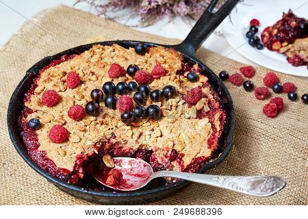 Summer Breakfast. Crumble With Blueberries In The Black Cast-iron Frying Pan On The White Table. Top