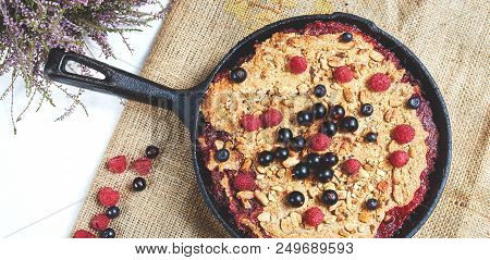 Summer Breakfast. Crumble With Blueberries In The Black Cast-iron Frying Pan On The White Table. Top