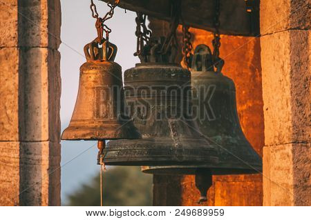 Kutaisi, Georgia. Close View Of Bells In Bell Tower Of Gelati Monastery In Evening Time.