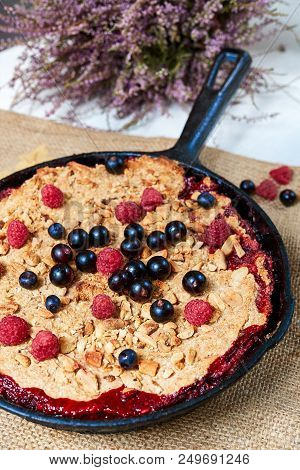 Summer Breakfast. Crumble With Blueberries In The Black Cast-iron Frying Pan On The White Table. Top