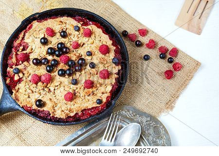Summer Breakfast. Crumble With Blueberries In The Black Cast-iron Frying Pan On The White Table. Top