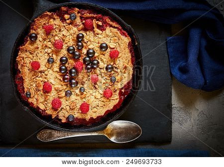 Summer Breakfast. Crumble With Blueberries In The Black Cast-iron Frying Pan On The Dark Stone Table