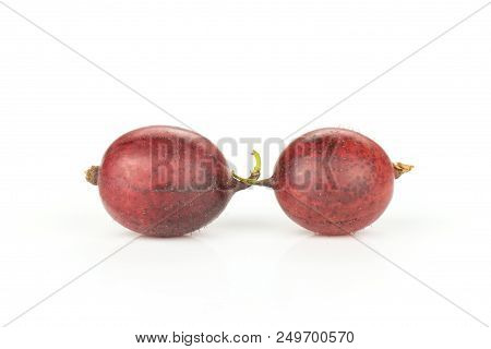Group Of Two Whole Fresh Red Gooseberry Hinnomaki Variety Isolated On White