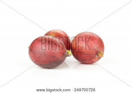 Group Of Three Whole Fresh Red Gooseberry Hinnomaki Variety Isolated On White