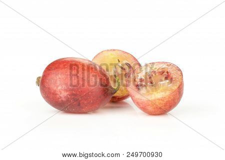 Group Of One Whole Two Halves Of Fresh Red Gooseberry Hinnomaki Variety Isolated On White