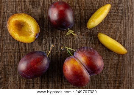 Group Of Three Whole One Half Two Slices Of Fresh Violet-blue Plum Vibrant Moyer Variety Flatlay On 