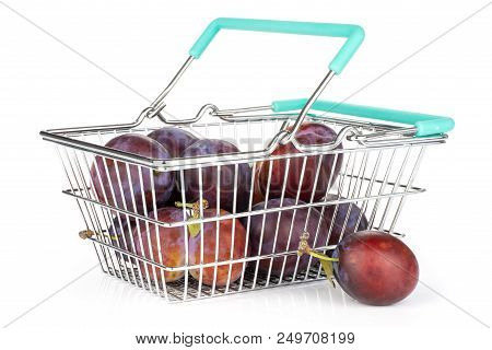 Lot Of Whole Fresh Violet-blue Plum Vibrant Moyer Variety In A Shopping Basket Isolated On White