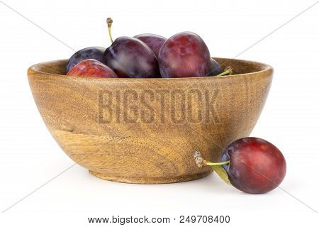 Lot Of Whole Fresh Violet-blue Plum Vibrant Moyer Variety In A Wooden Bowl Front View Isolated On Wh