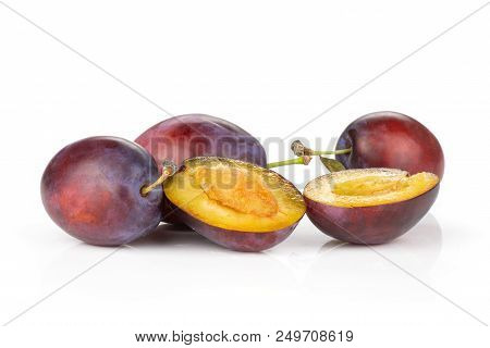 Group Of Three Whole Two Halves Of Fresh Violet-blue Plum Vibrant Moyer Variety Isolated On White