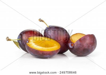 Group Of Three Whole One Half One Piece Of Fresh Violet-blue Plum Vibrant Moyer Variety Isolated On 