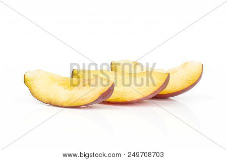 Group Of Three Slices Of Fresh Violet-blue Plum Vibrant Moyer Variety Isolated On White