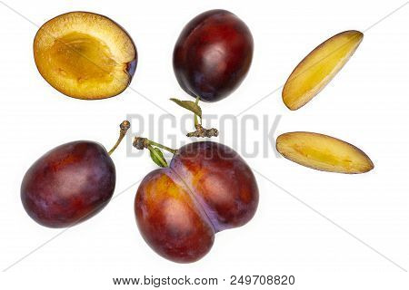 Group Of Three Whole One Half Two Slices Of Fresh Violet-blue Plum Vibrant Moyer Variety Flatlay Iso