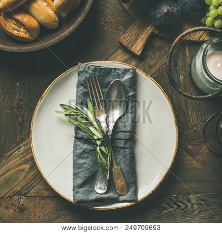 Fall Holiday Table Decoration Setting. Plate With Linen Napkin, Fork And Spoon, Candle, Fresh Fruits