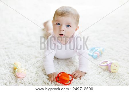 Cute Baby Playing With Colorful Pastel Vintage Rattle Toy. New Born Child, Little Girl Looking At Th