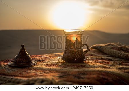 Arabian Tea In Glass On A Eastern Carpet. Eastern Tea Concept. Armudu Traditional Cup. Sunset Backgr