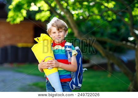 Happy Little Kid Boy In Colorful Shirt And Backpack Or Satchel And Traditional German School Bag Con