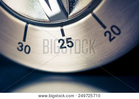25 Minutes - A Macro Of An Analog Chrome Kitchen Timer With Dark Background And Reflection