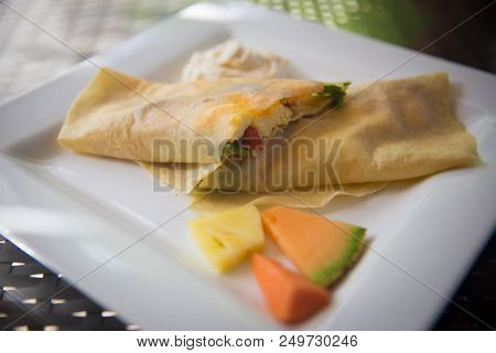 Crepe Stuffed With Eggs, Bacon, Spinach And Cheese