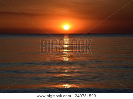 The Sun Casts Orange Shades Across An Evening Sky At Mindil Beach (darwin, Northern Territory, Austr