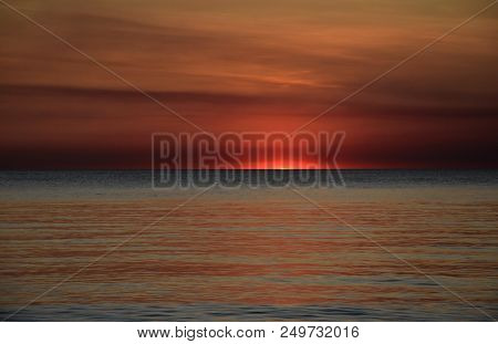 The Sun Casts Orange Shades Across An Evening Sky At Mindil Beach (darwin, Northern Territory, Austr