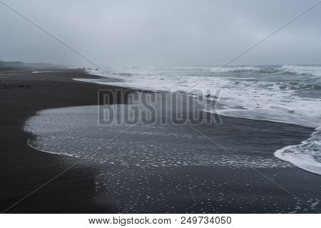 Black Volcanic Sand At Khalaktyrsky Beach Of The Pacific At Kamchatka Peninsula, Near Petropavlovsk-
