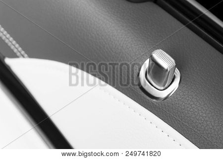 Door Handle With Lock Contol Buttons Of A Luxury Passenger Car. Black Leather Interior Of The Luxury